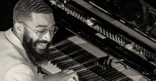 black and white picture of a man at a piano